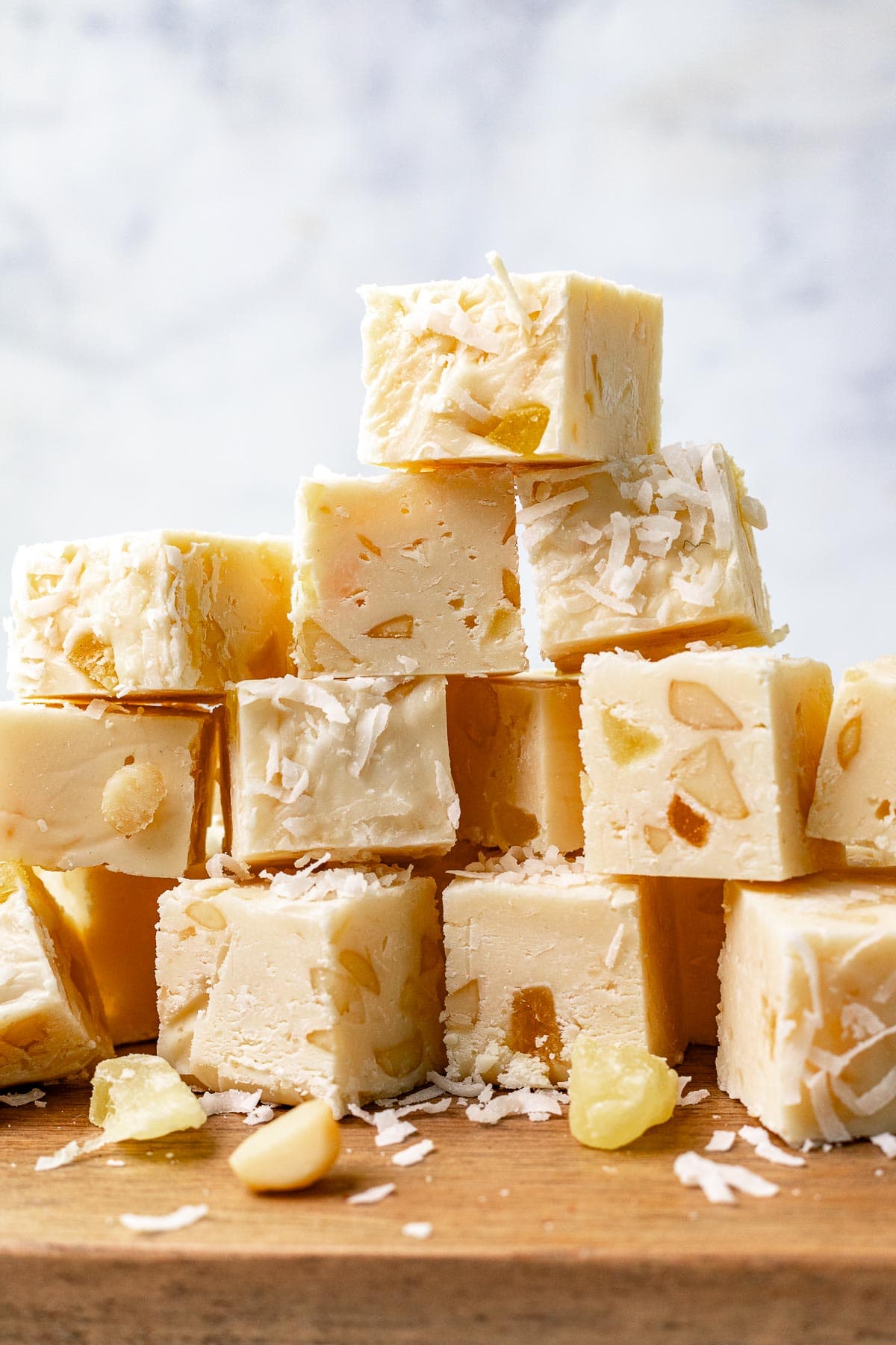 Pina Colada Fudge squares stacked on each other, side view