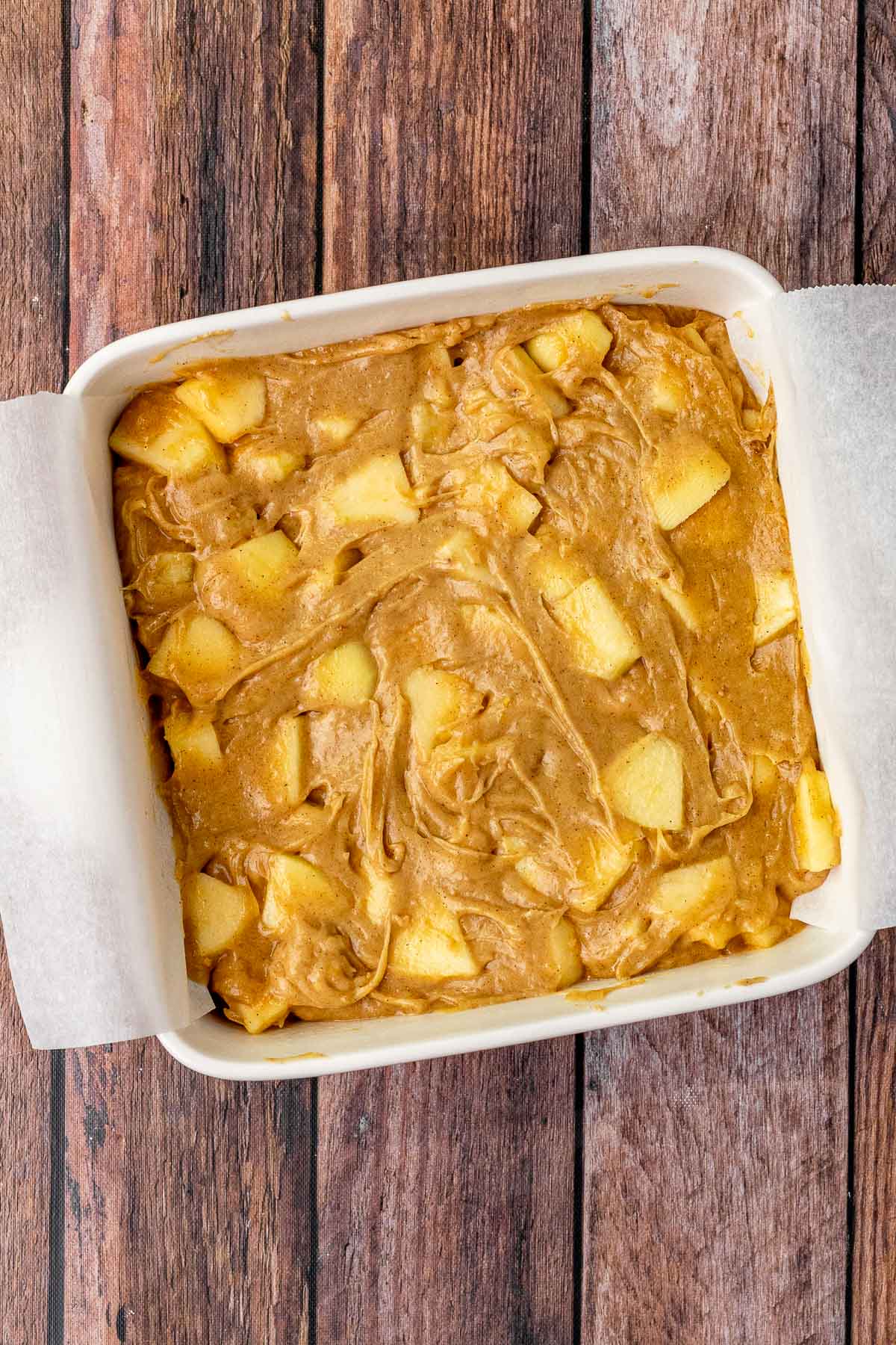Toffee Apple Brownie Bars batter in baking dish before baking