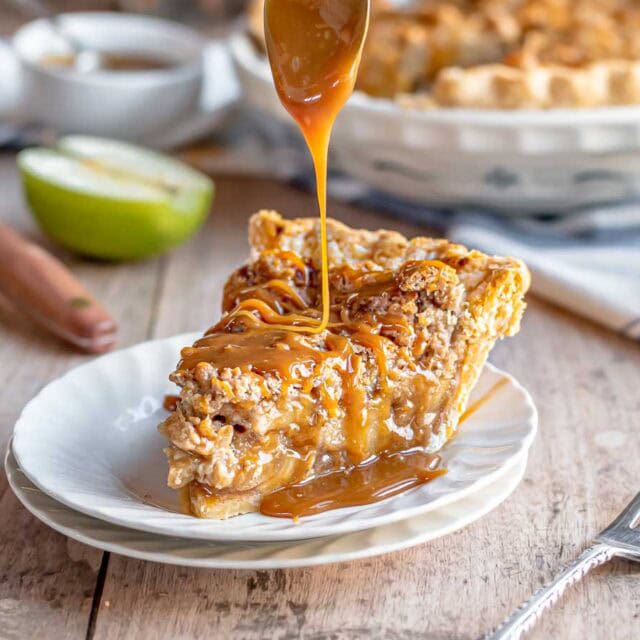 Caramel sauce drizzled on slice of pie.