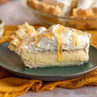 Slice of custard style pie on plate.