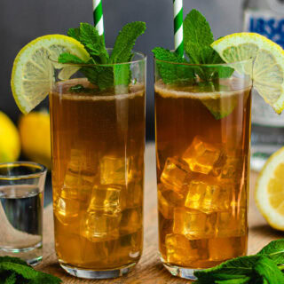 Two teas in Collins glasses with ice, and lemon garnish.