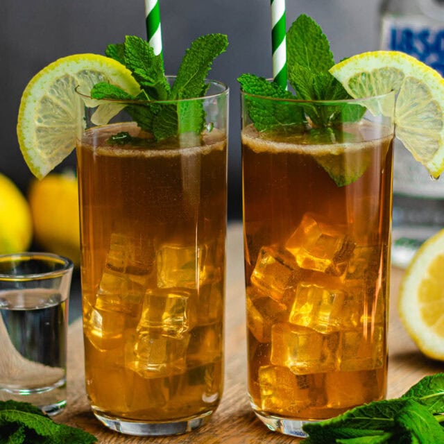 Two teas in Collins glasses with ice, and lemon garnish.