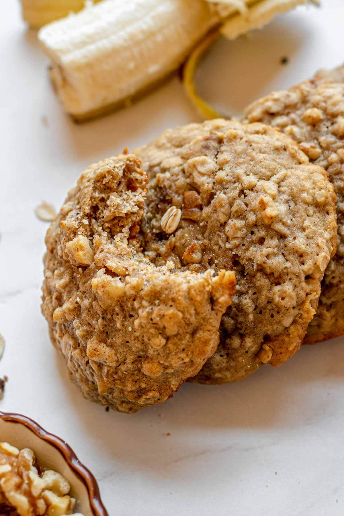 Banana Bread Cookies baked cookie with bite missing propped on other baked cookies