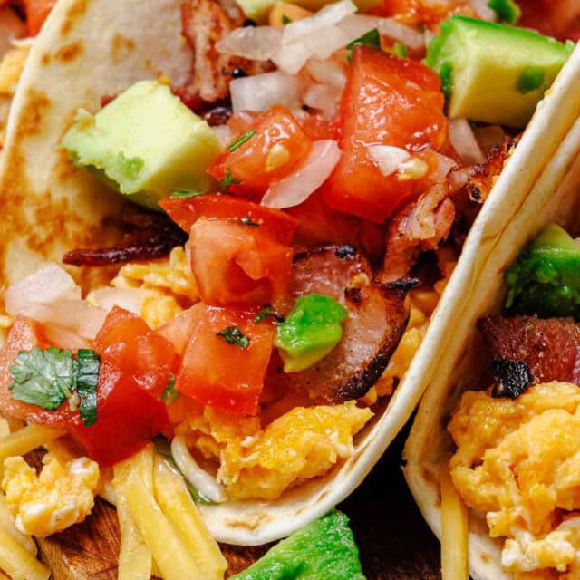Close up of taco filled with breakfast ingredients.