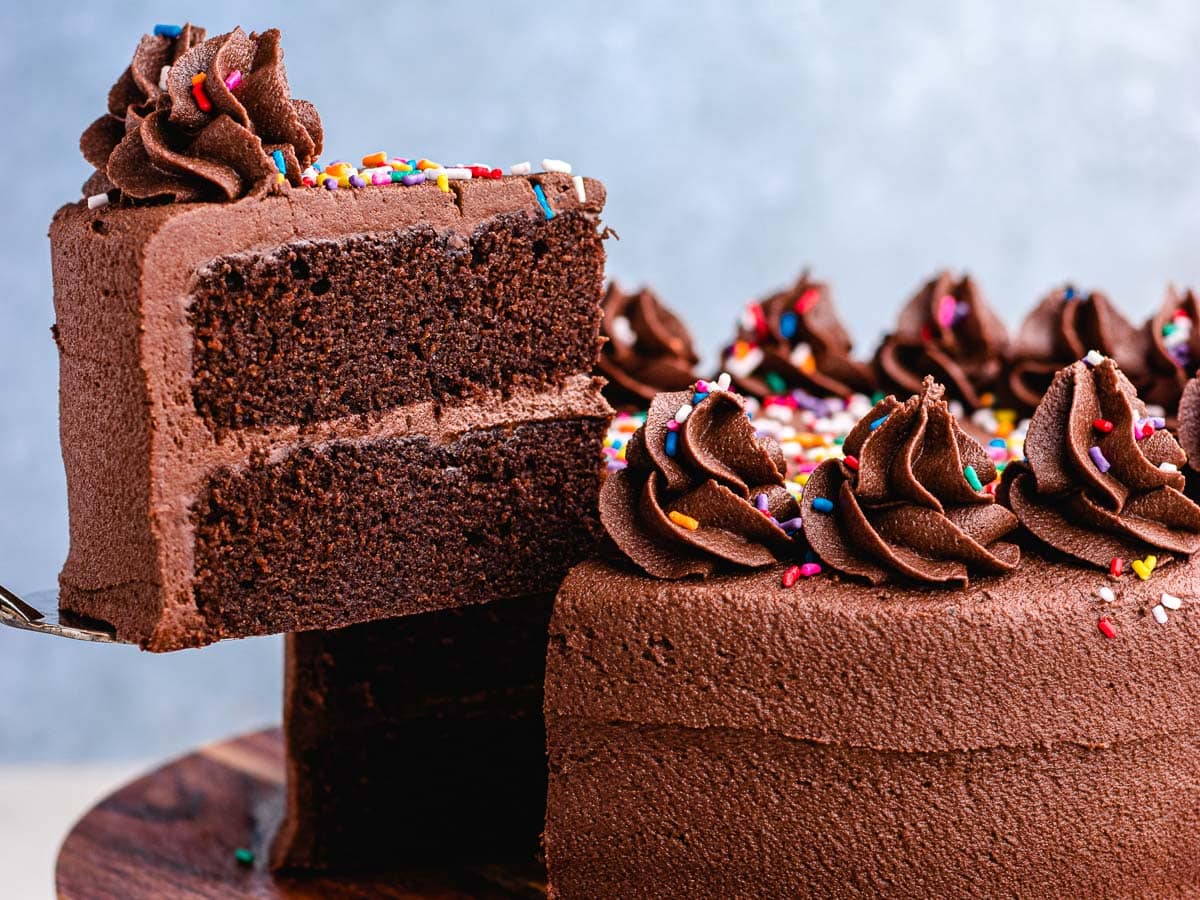 Large piece of cake being served from cake plate.