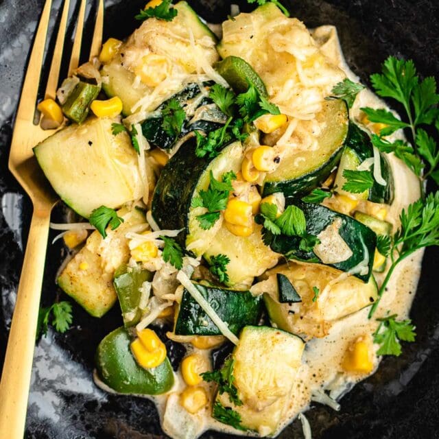Sautéed vegetables in a light cheese and cream sauce on plate.