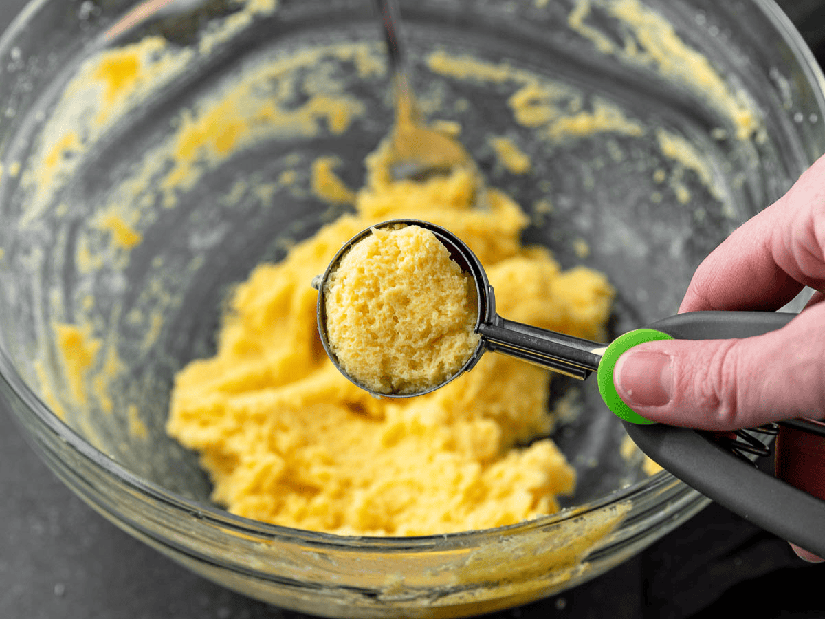Pudding and cream cheese mix being scooped into balls.