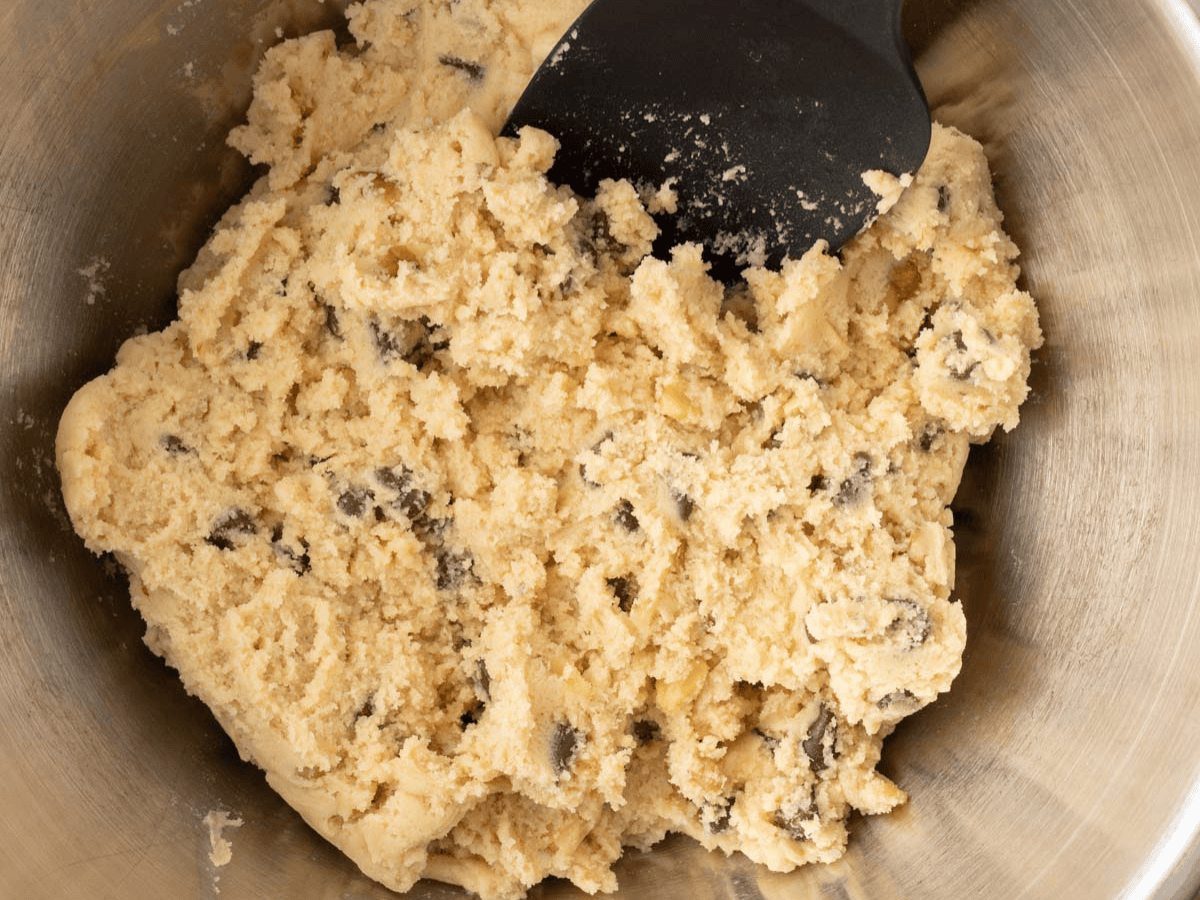 Cookie dough in bowl with spatula.