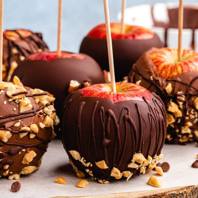 Apples coated in chocolate and nuts.