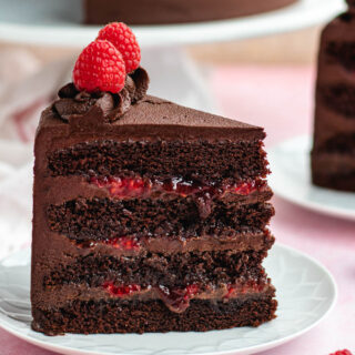 Slice of decorated cake on small plate.
