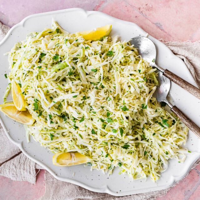 Large serving plate with shredded cabbage.