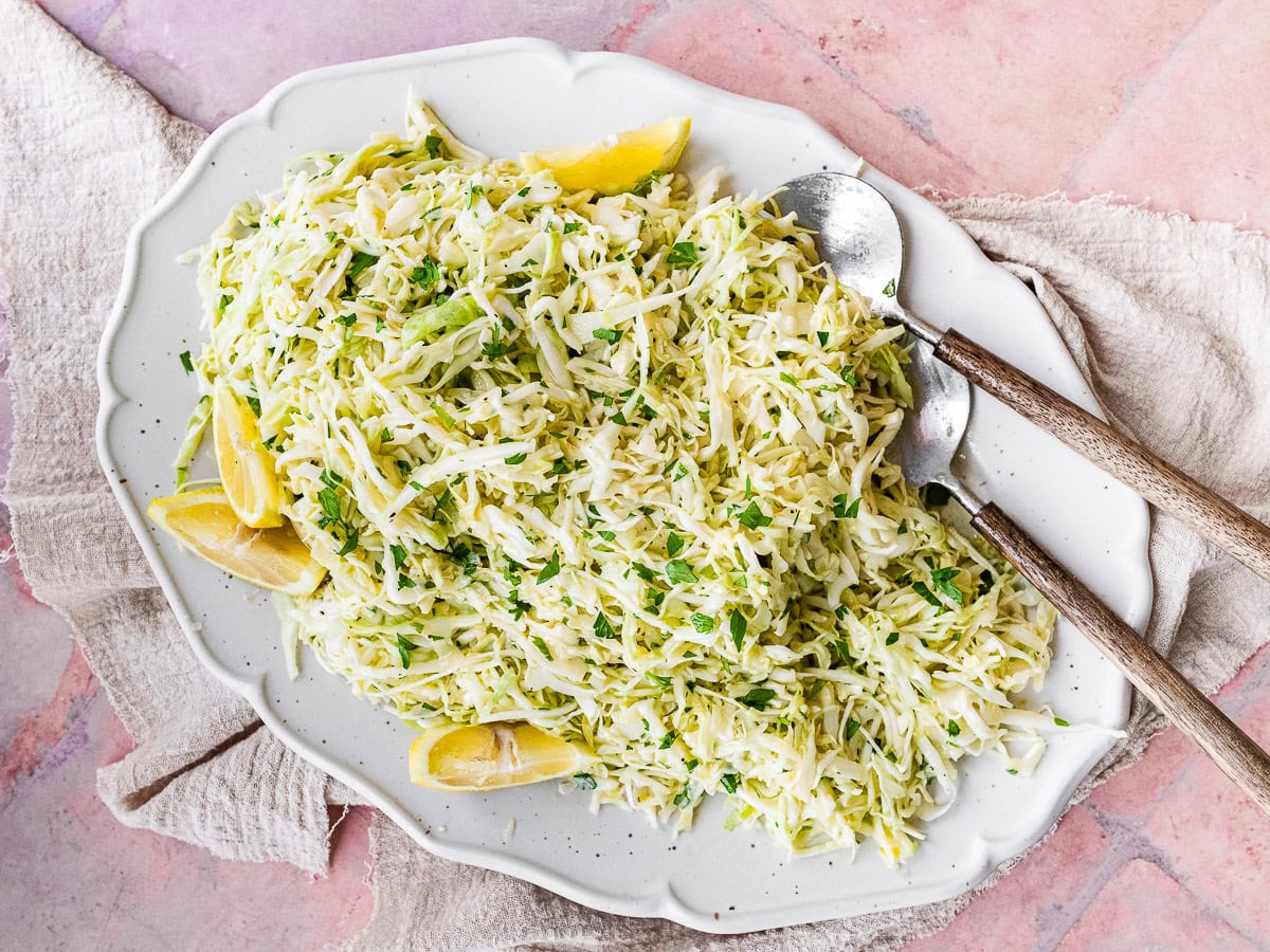 Large serving plate with shredded cabbage.