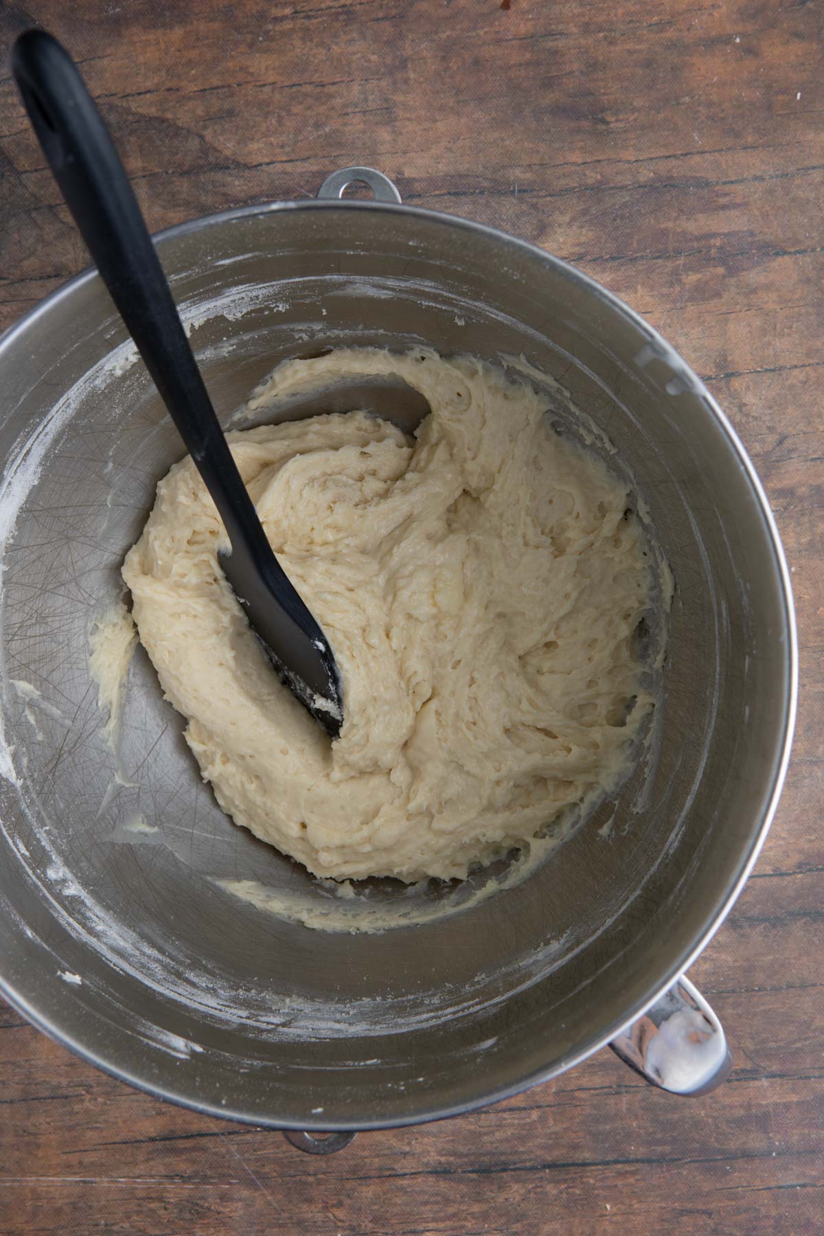 Coconut Cupcakes wet batter ingredients in mixing bowl with spatula