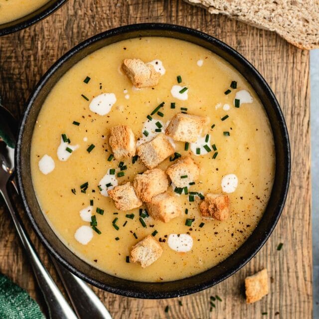 Creamy potato soup in bowl with croutons.