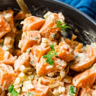 Closeup of salad in a bowl with a spoon ready to serve