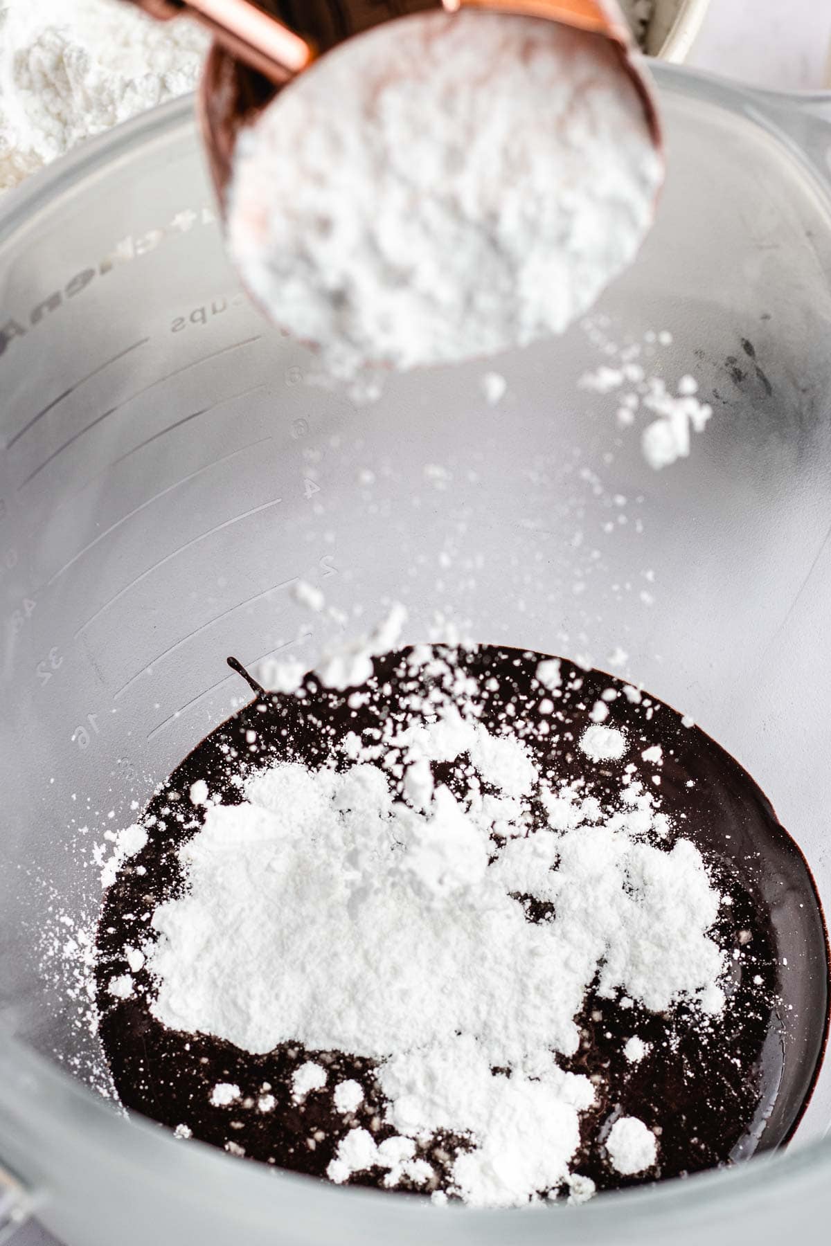Dark Chocolate Frosting adding powdered sugar to chocolate mixture