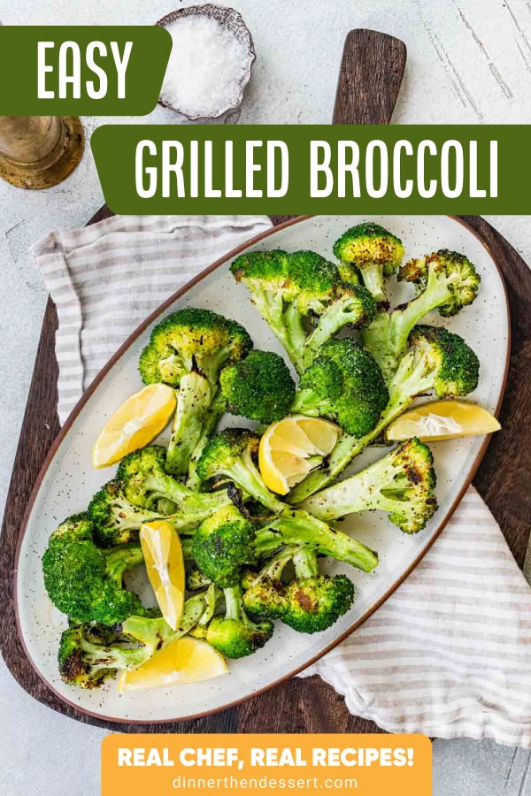 Grilled broccoli on serving plate with lemon wedges.