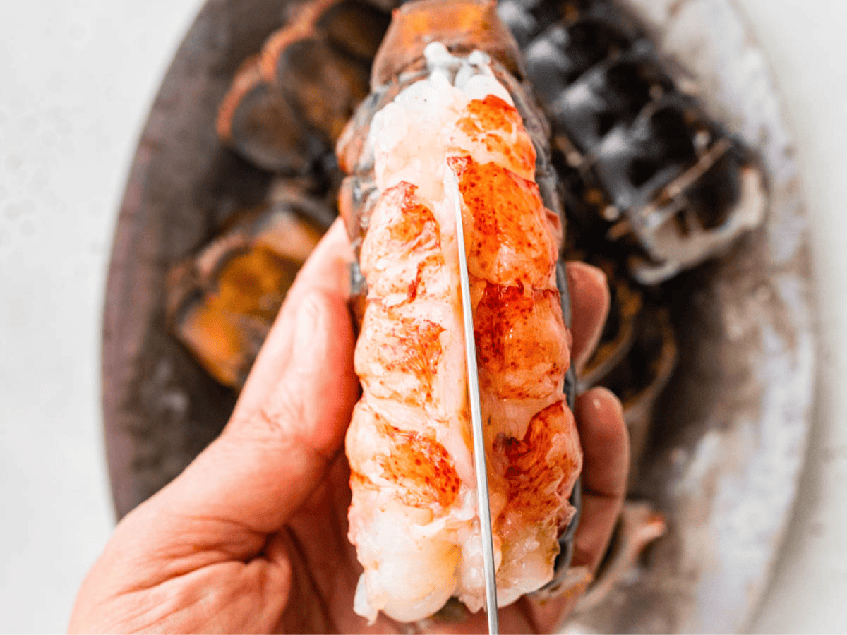 Knife filleting open lobster tail.