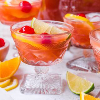 Cocktail glass with fruity drink and garnish.