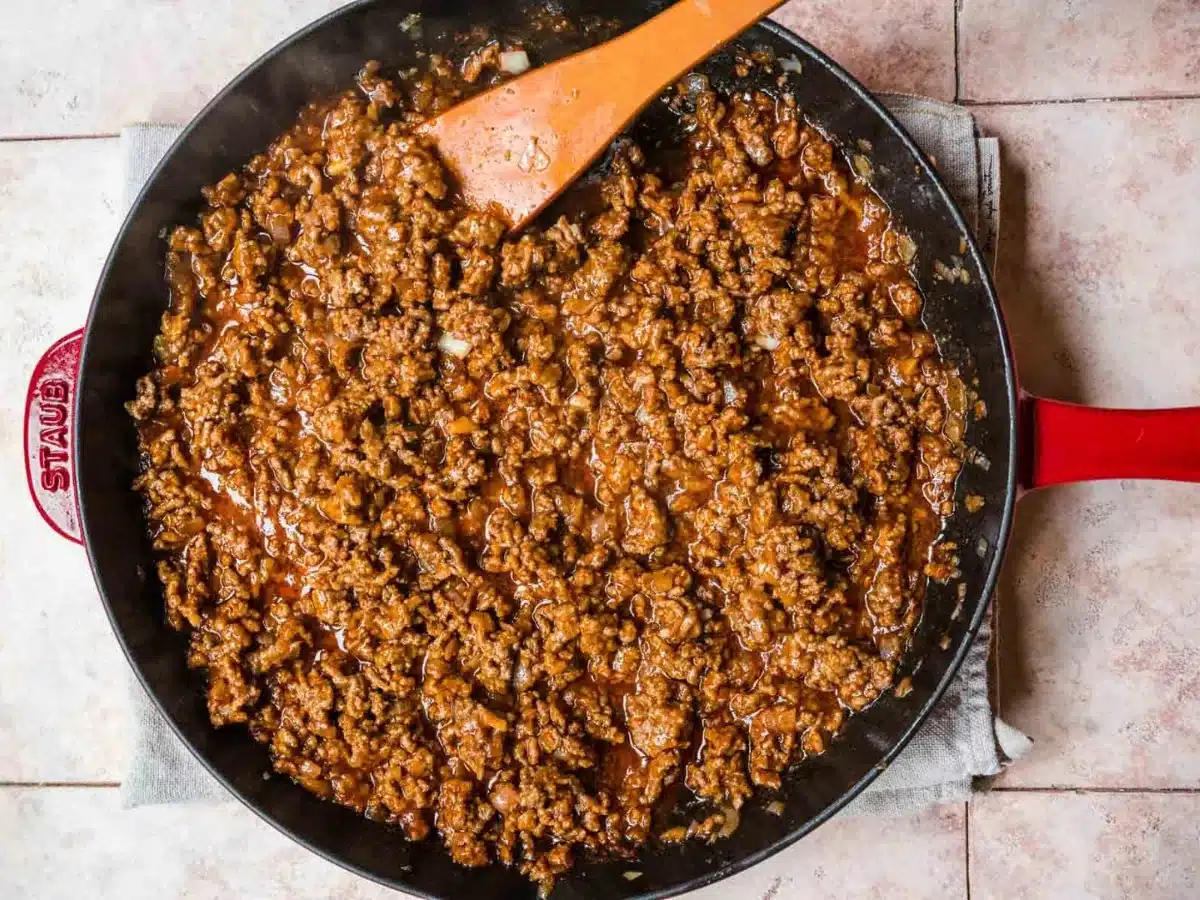 mixing the meat in a skillet