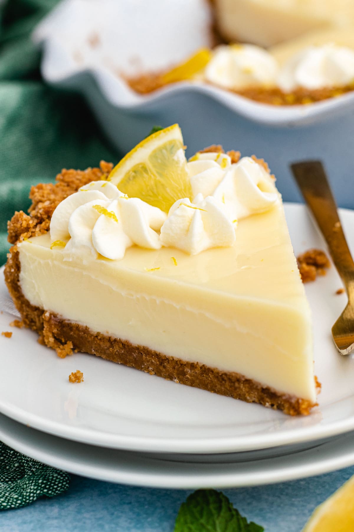 Lemon Pie slice of pie on plate with pie plate with fork