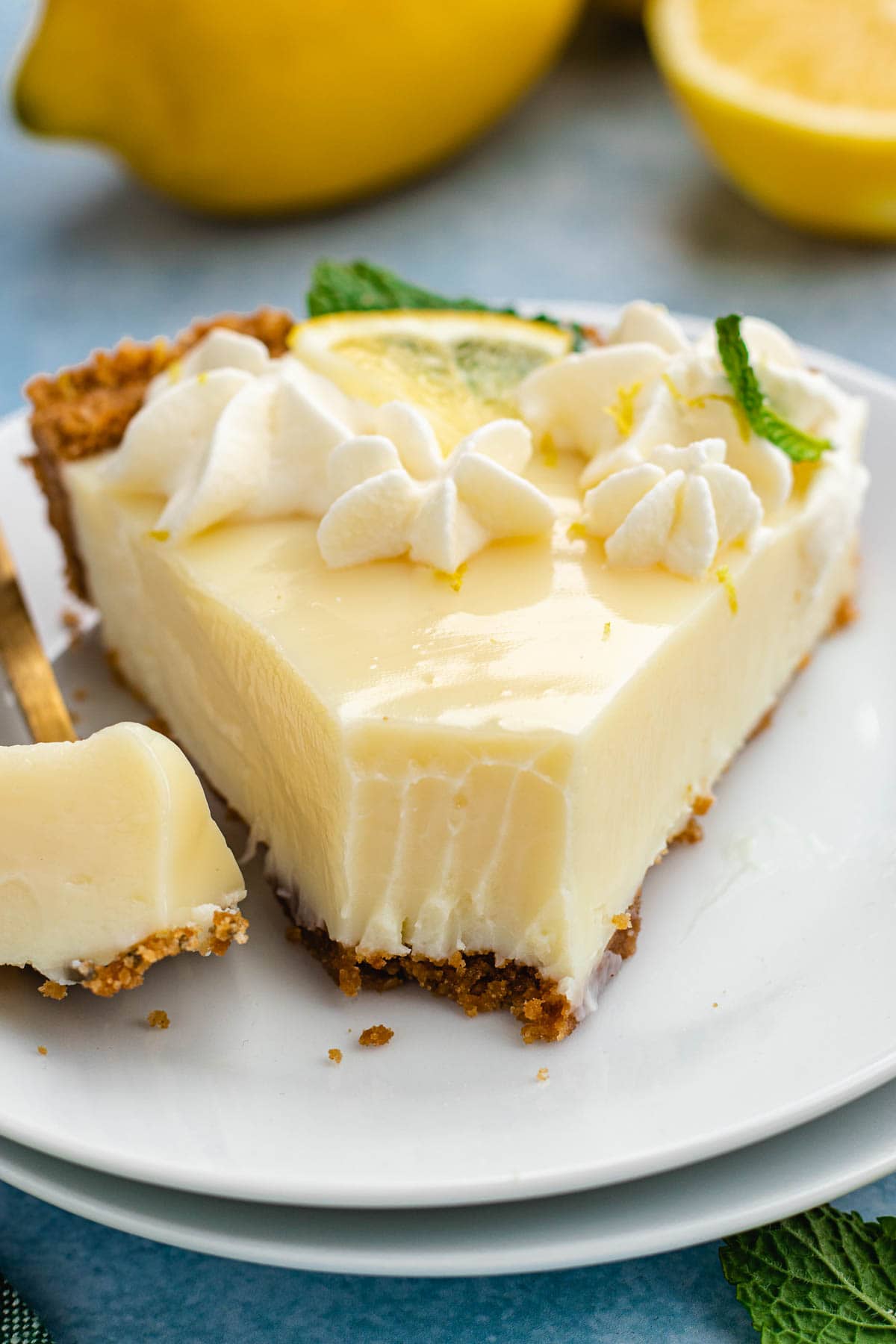 Lemon Pie slice of pie on plate with bite cut out on fork