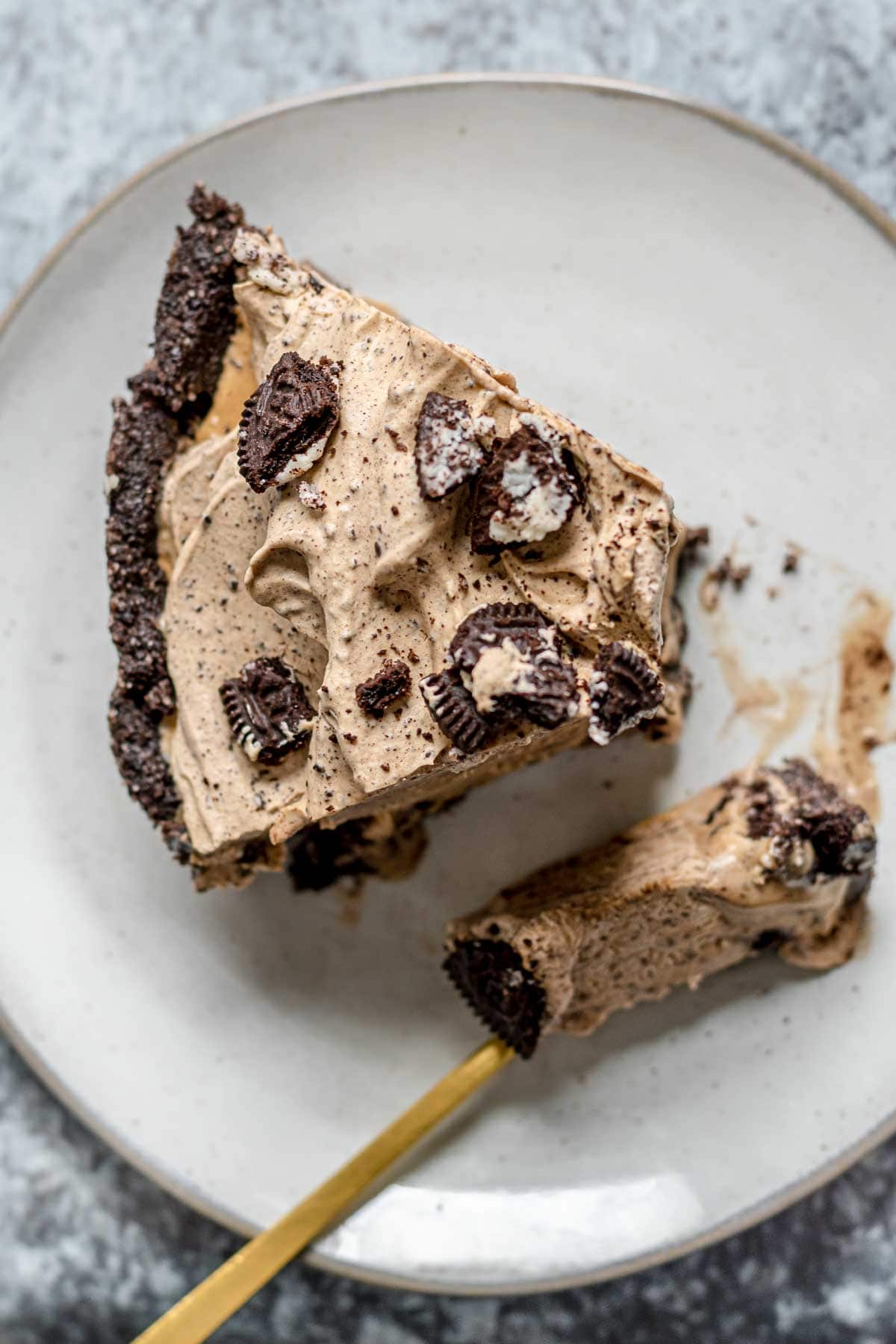 Oreo Coffee Ice Cream Pie slice on plate with bite on fork