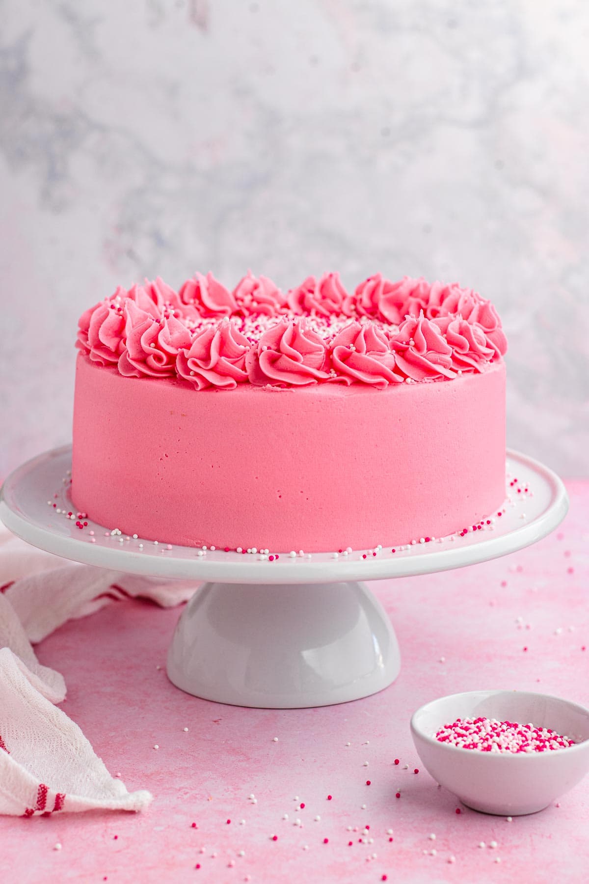 decorated full cake on white cake stand