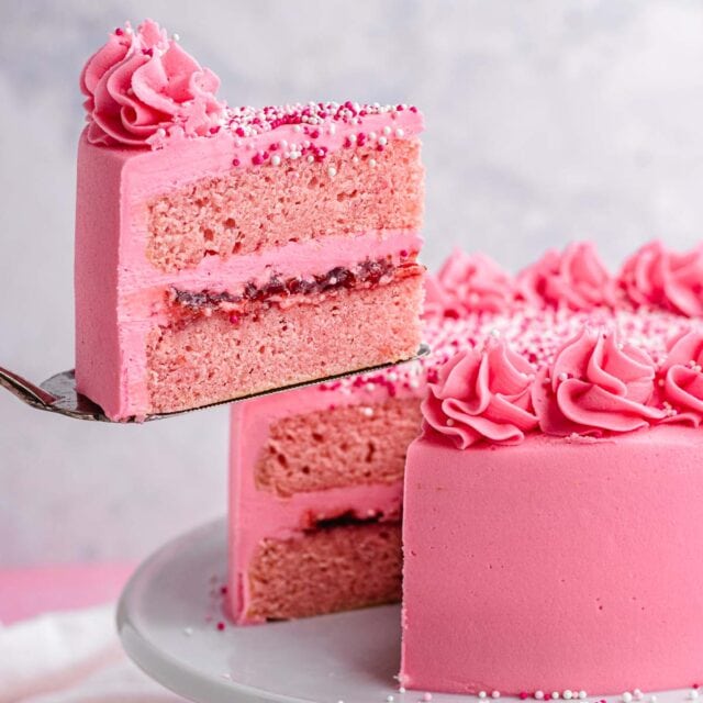 Pink Velvet Cake removing slice from cake on cake stand. 1x1