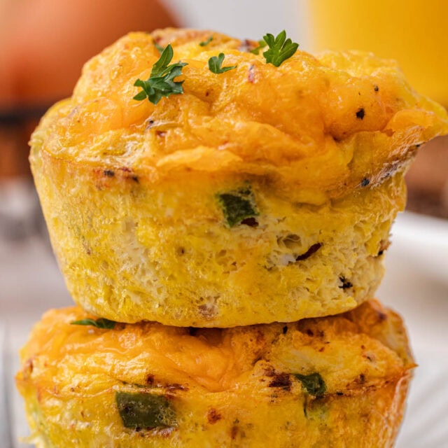 Two savory breakfast muffins stacked on top of each other.