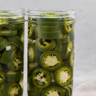 Sliced and pickled peppers in canning jars.