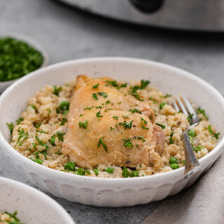 Chicken thighs with rice and peas in bowl 4x3