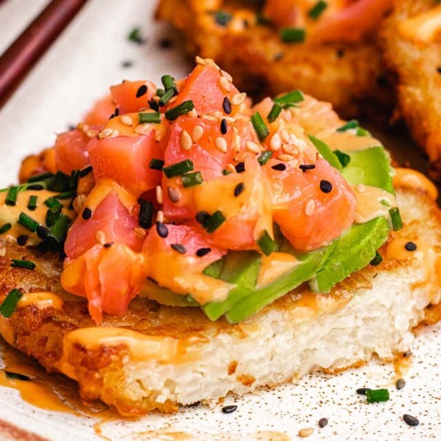 Salmon, avocado, and spicy mayo on top of fried patty.
