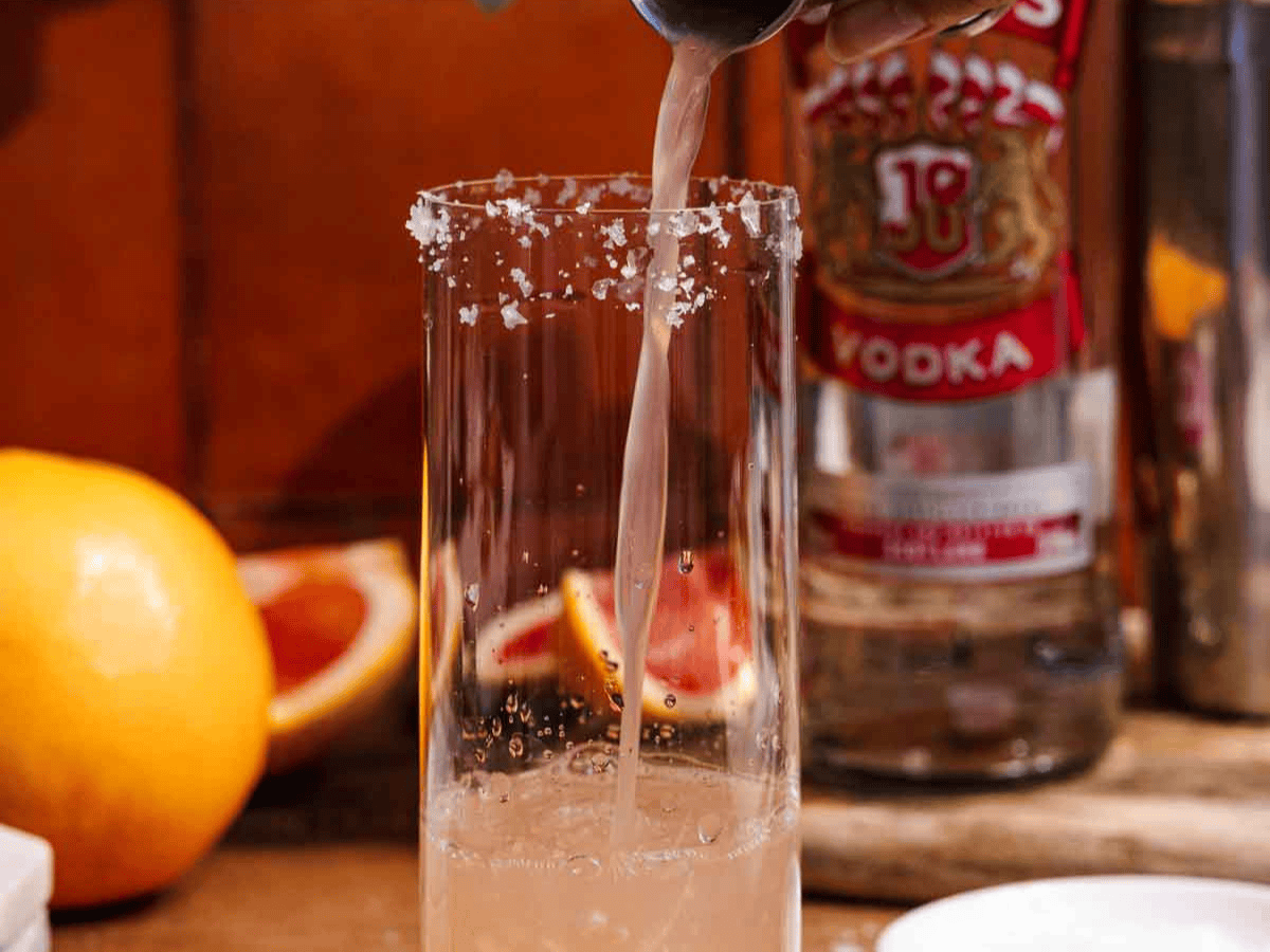 Grapefruit juice being poured into glass.