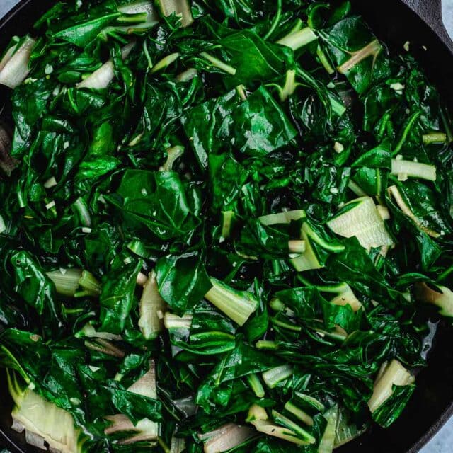 Large pan with sautéed leafy greens.