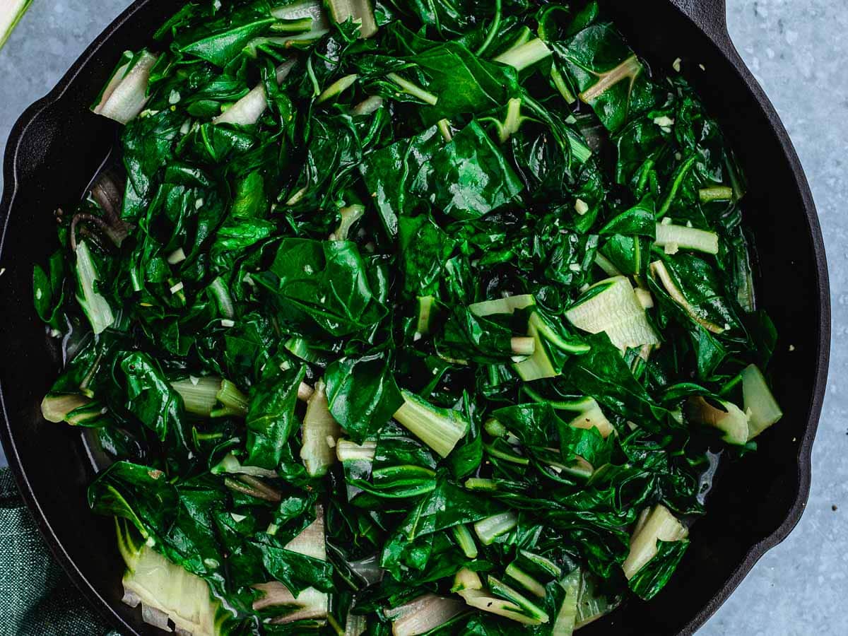 Large pan with sautéed leafy greens.