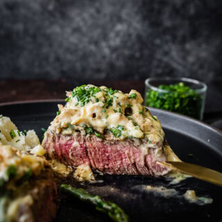 Plated Steak Oscar sliced in half to see inside.
