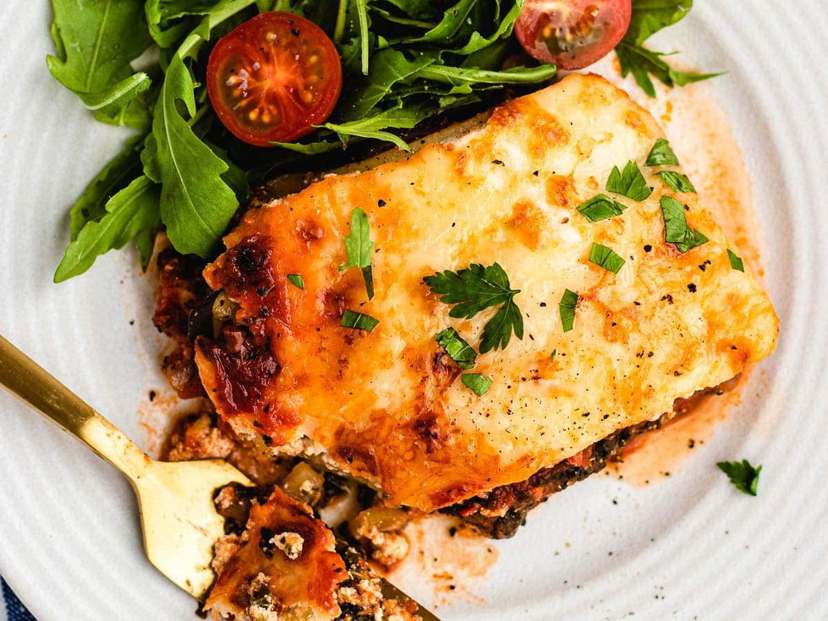 Piece of lasagna on plate.