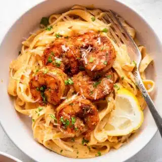 Shrimp and pasta dish in bowl with fork.