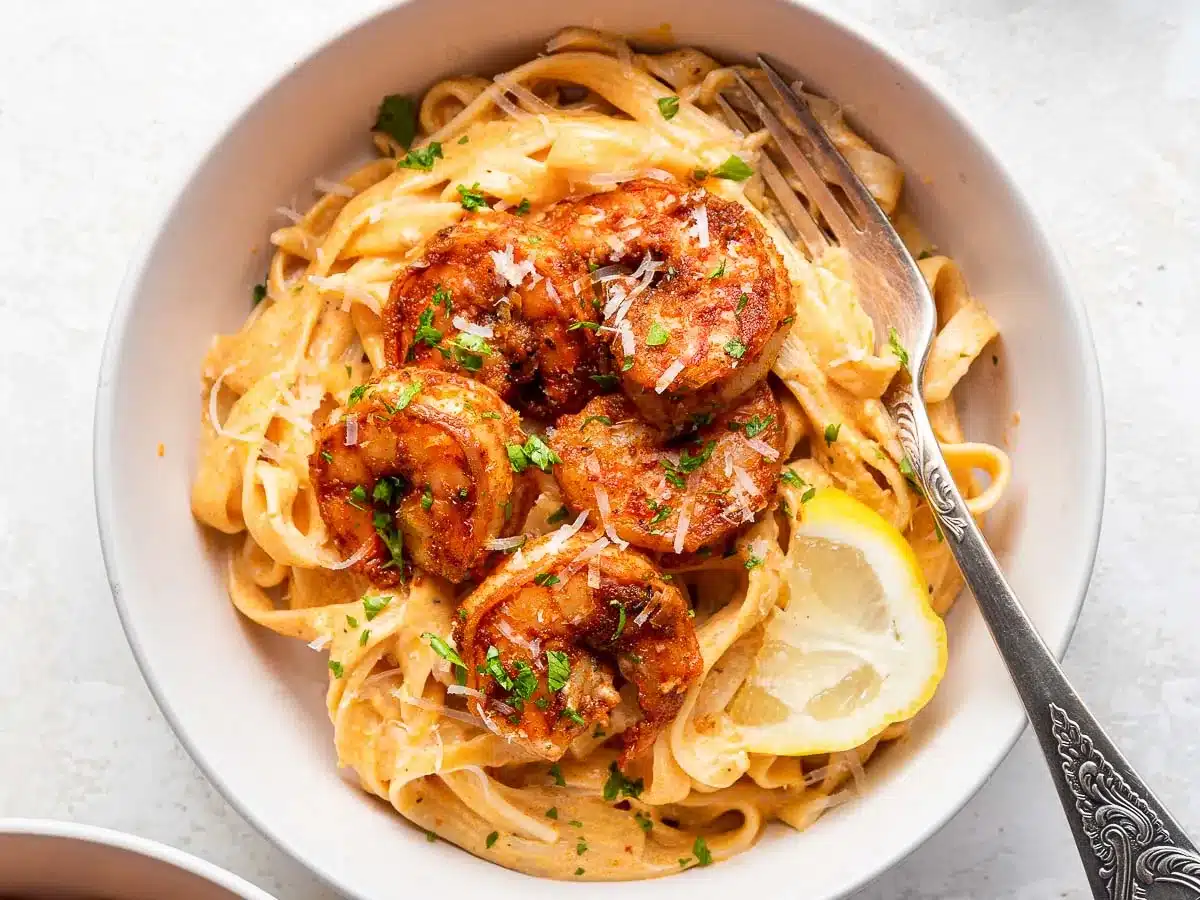 Shrimp and pasta dish in bowl with fork.