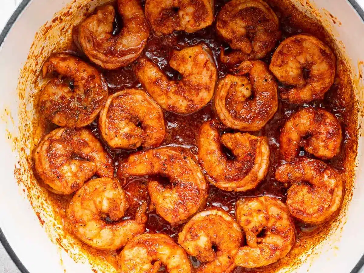 Cooked shrimp in pot with spicy seasoning.