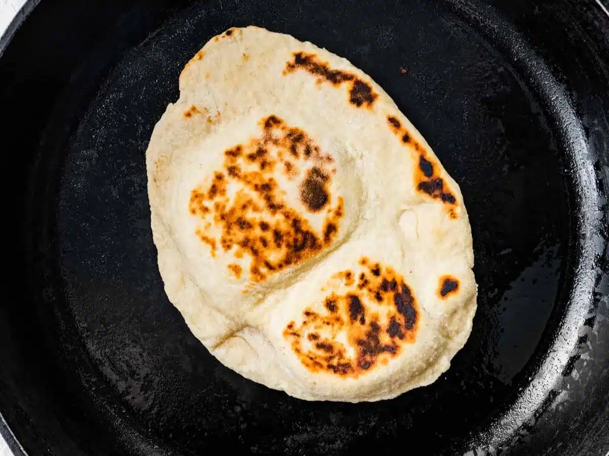 Flat and thin bread browned in pan.