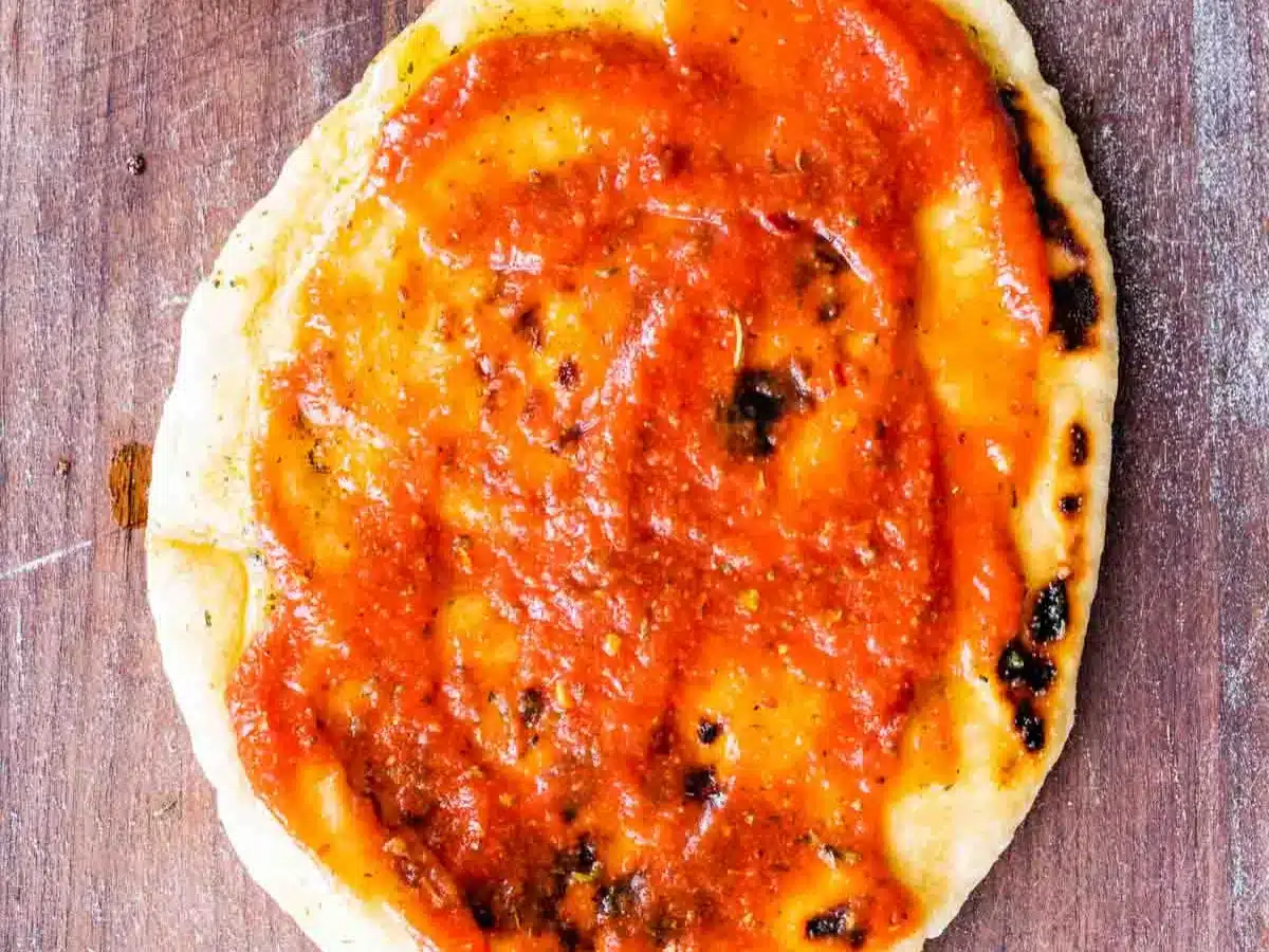 Sauce on thin bread round.