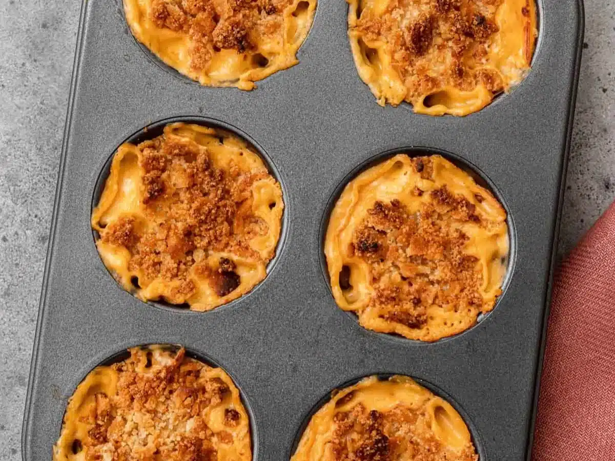 Baked cheesy pasta appetizer in muffin pan.