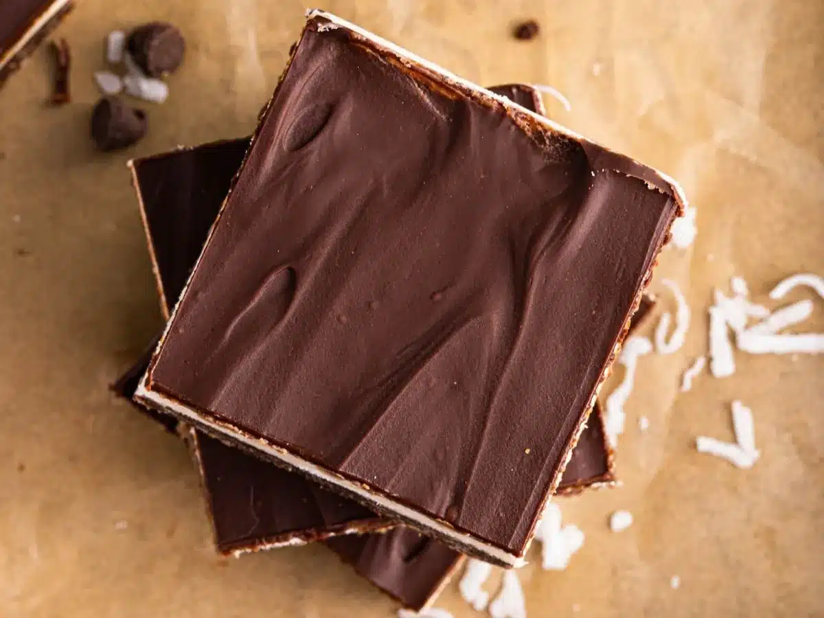 Stack of chocolatey layered dessert squares.