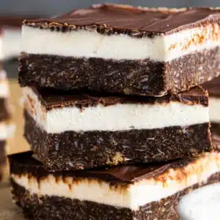 Stack of chocolatey layered dessert squares.