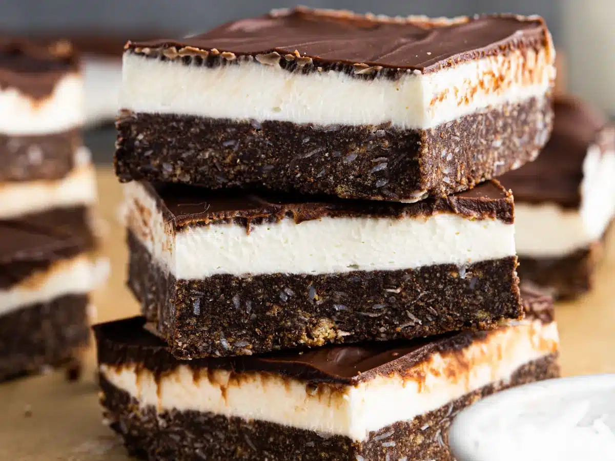 Stack of chocolatey layered dessert squares.