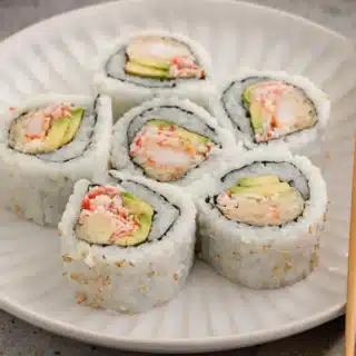 Pieces of sushi on a dinner plate.