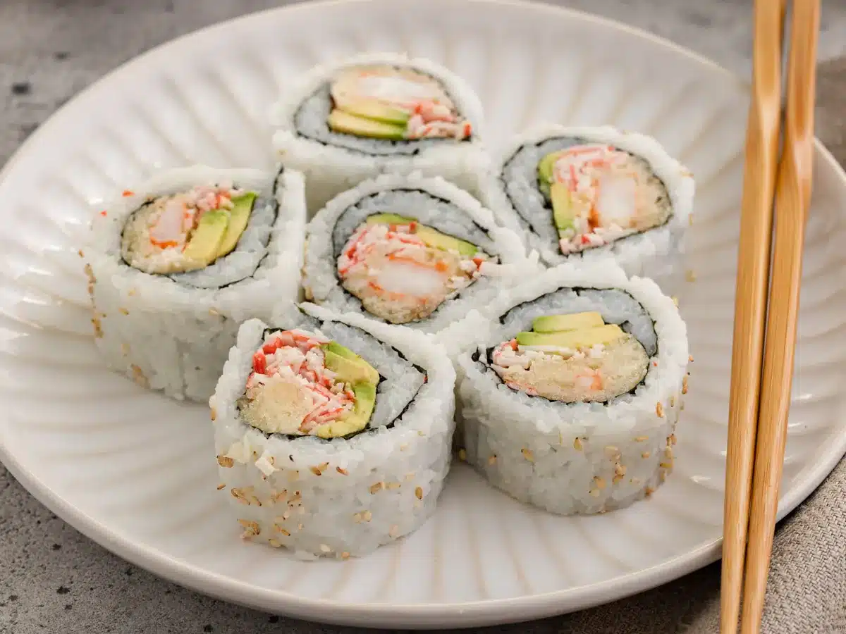Pieces of sushi on a dinner plate.