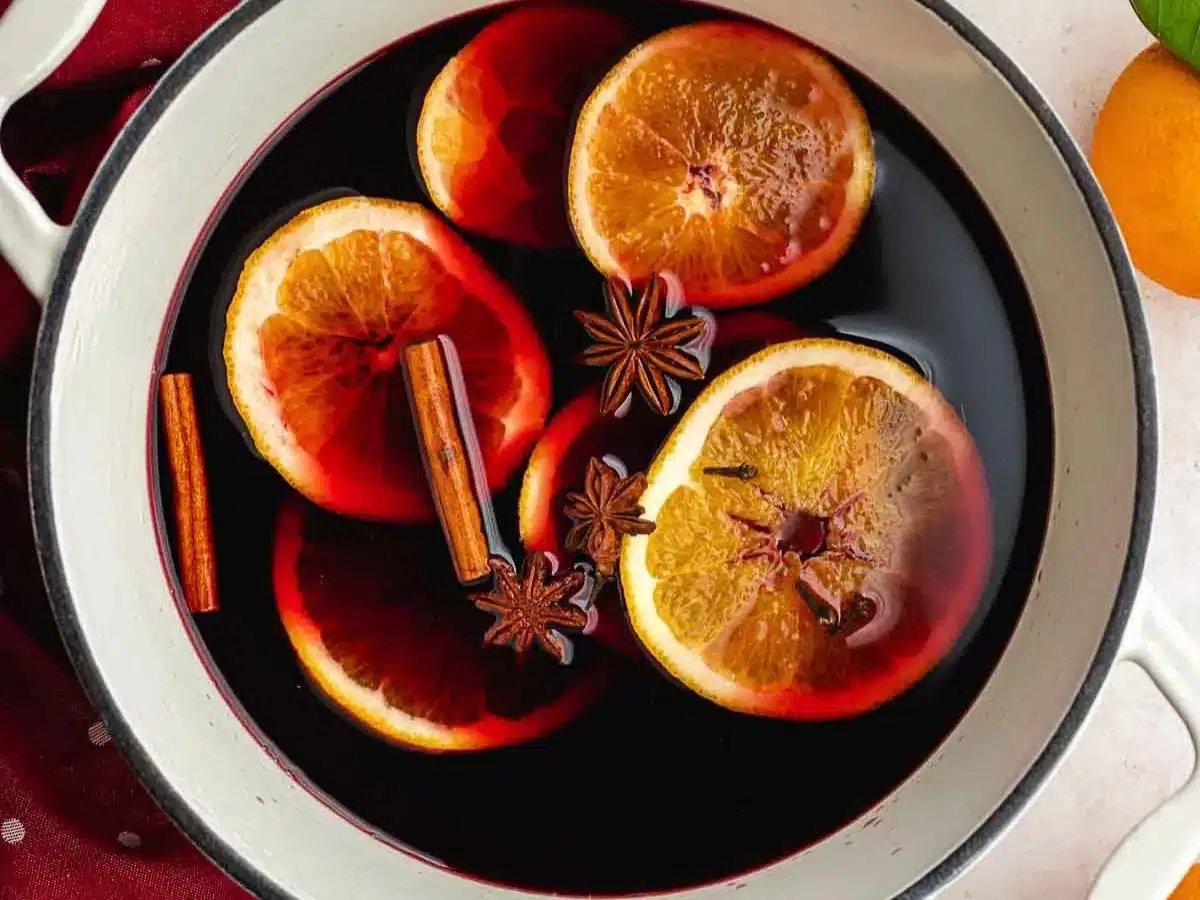Wine, brandy, orange slices, cinnamon, and anise in pot.
